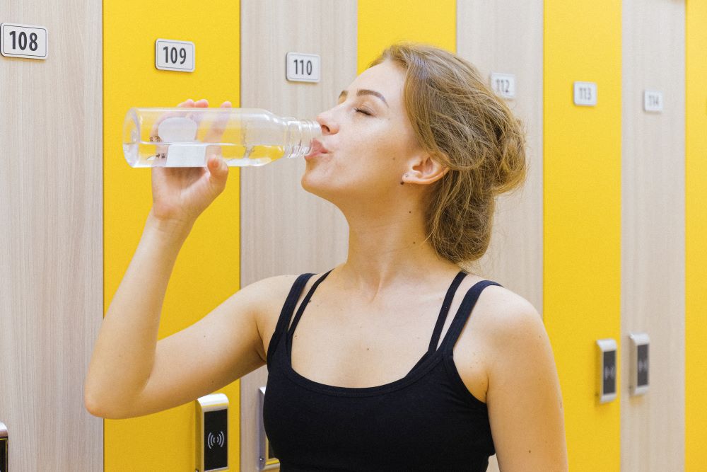 Lady drinking water from using Fluoride-Free Water Filter