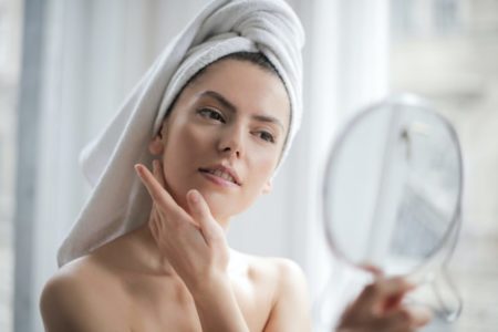 woman using olive oil in skincare
