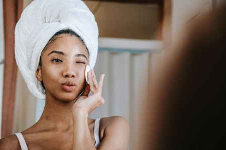 lady using products for facial cleansing