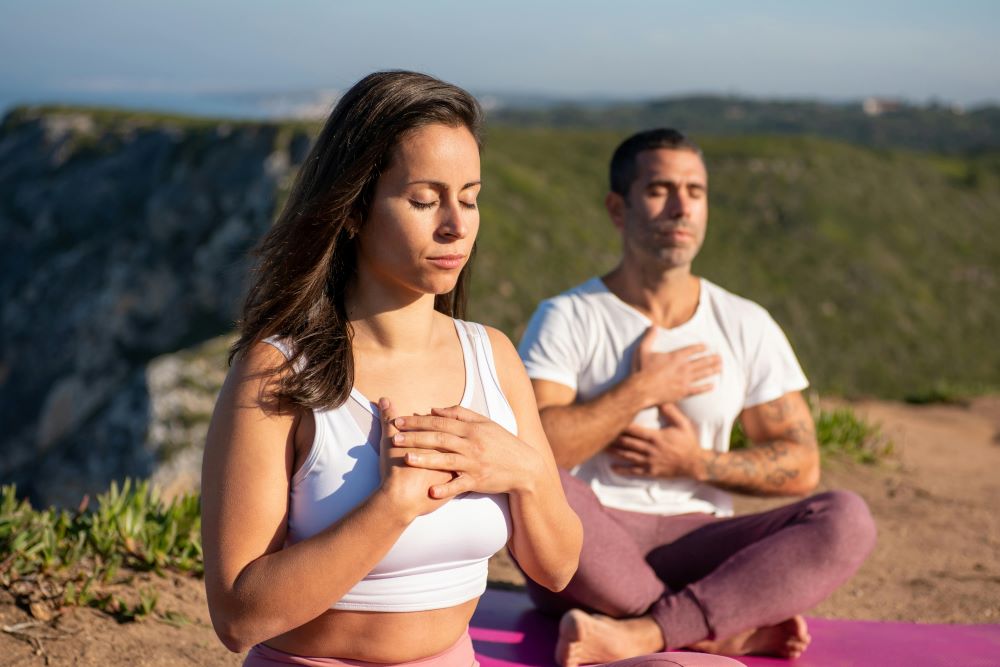 man and woman practising somatic workouts