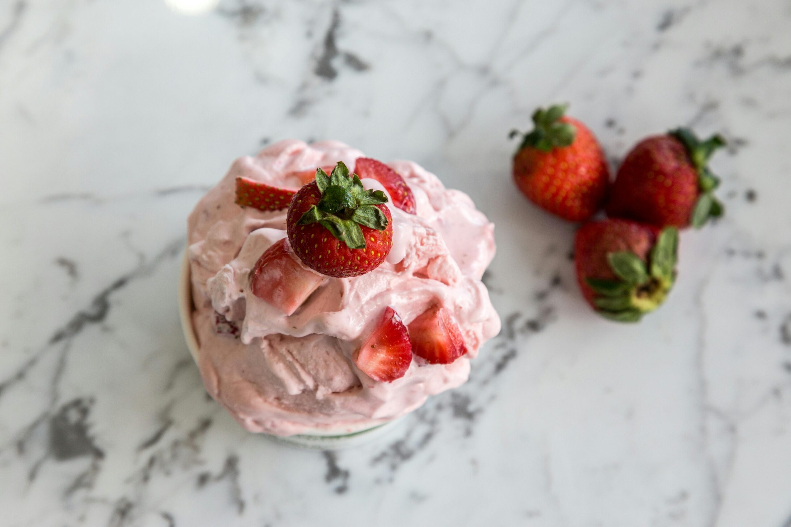 angel delight dessert with almond milk topped with strawberries and cream