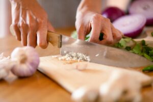 Chopping vegetables for making Bone Broth and the Health Benefits