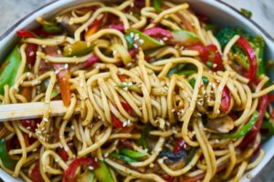 ginger chicken noodle salad sprinkled with sesame seeds